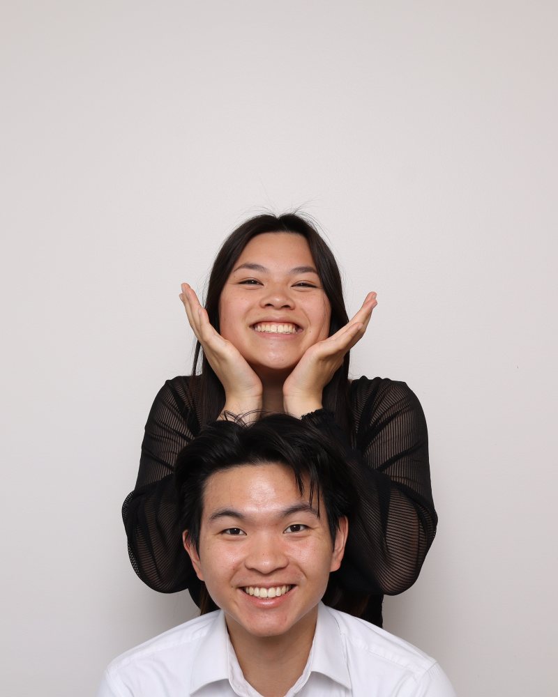 Two guests in a playful stacked pose in the Stella Booth